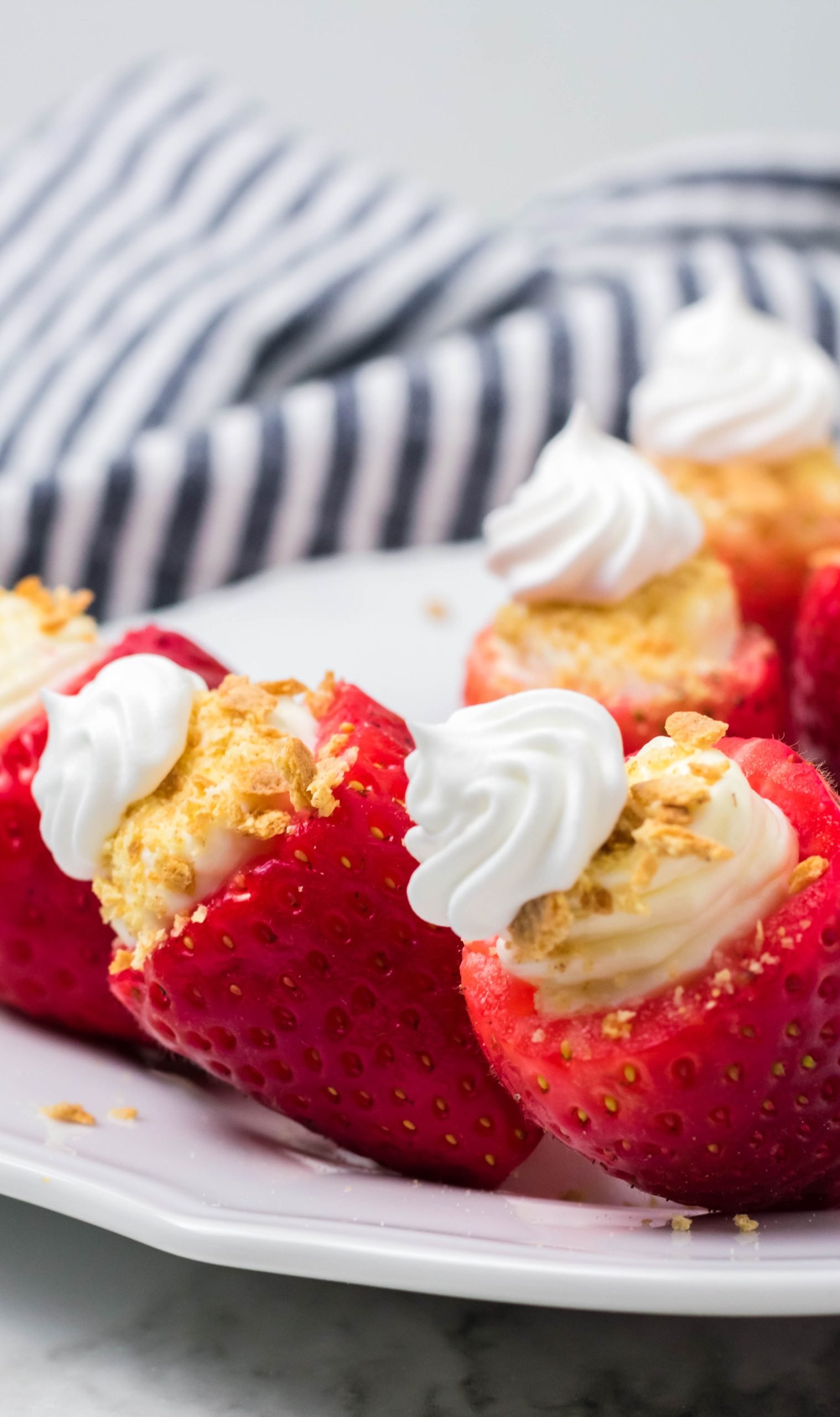 cheesecake stuffed strawberries on a white plate