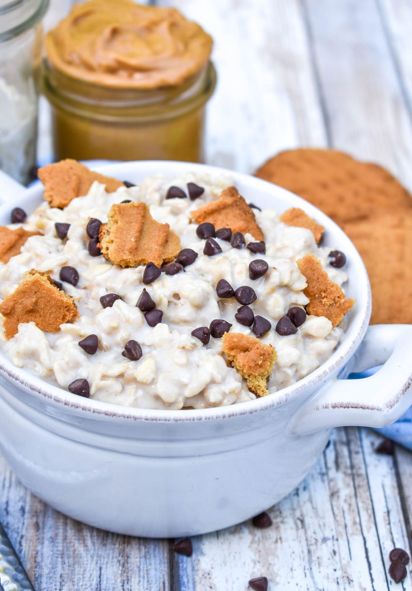 peanut butter cookie overnight oats in a bowl topped with crumbled cookies and miniature chocolate chips