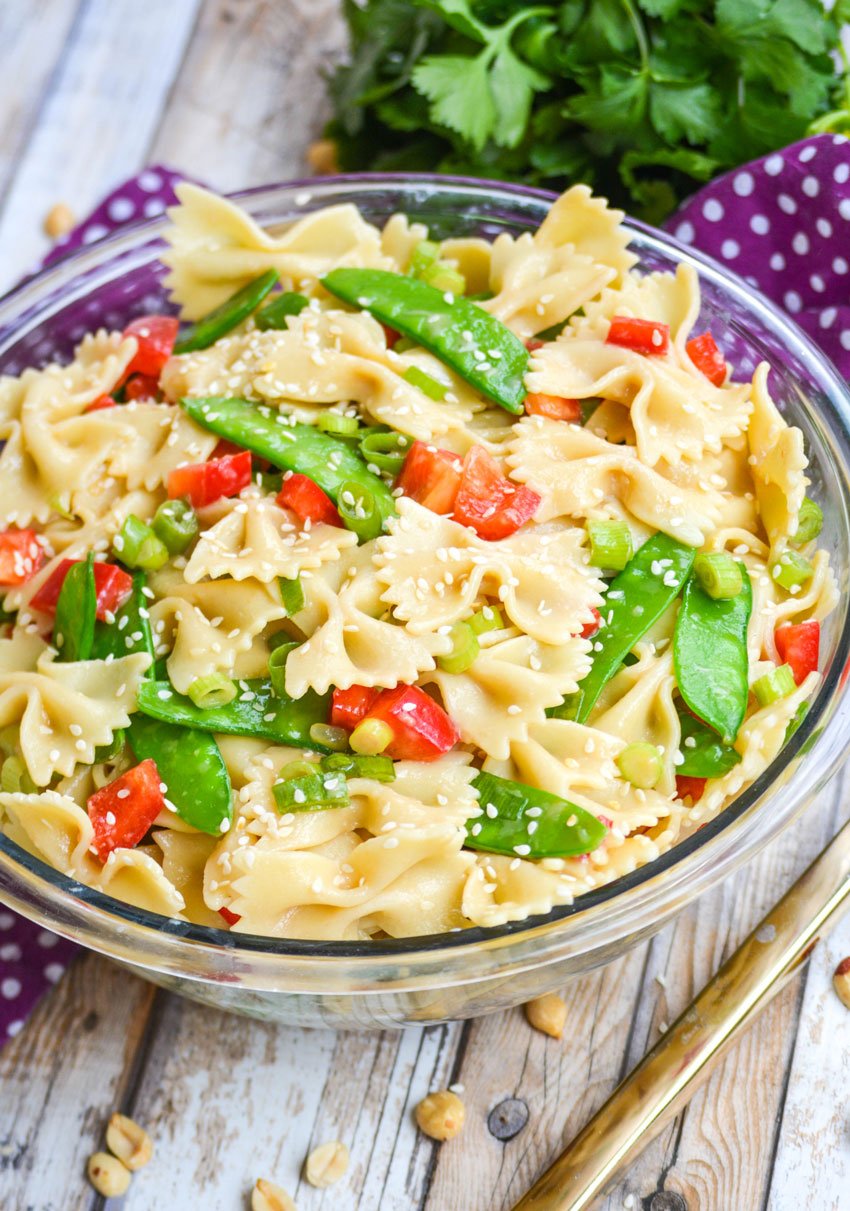 sesame ginger pasta salad in a glass mixing bowl