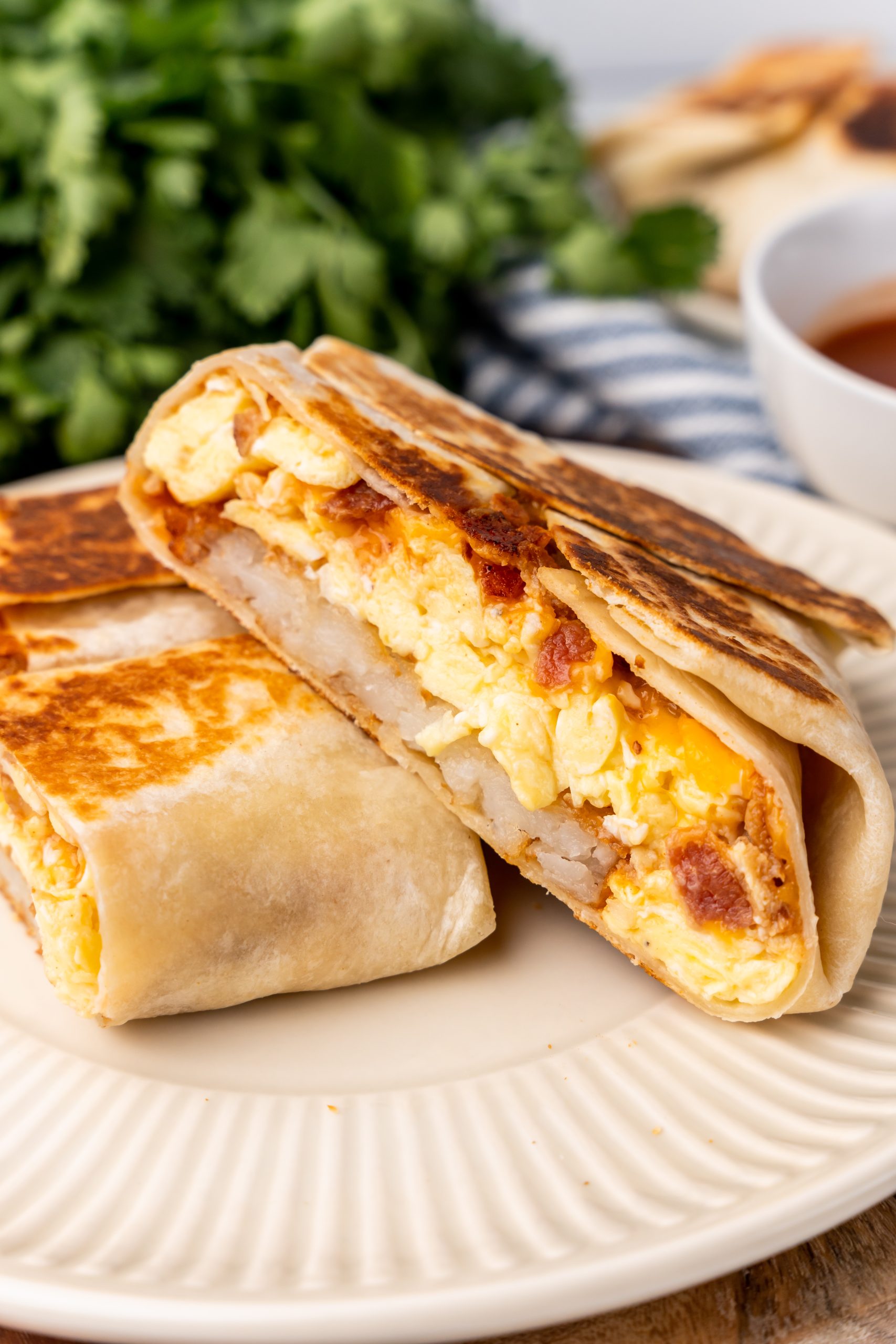 two halves of a copycat breakfast crunchwrap on a white plate