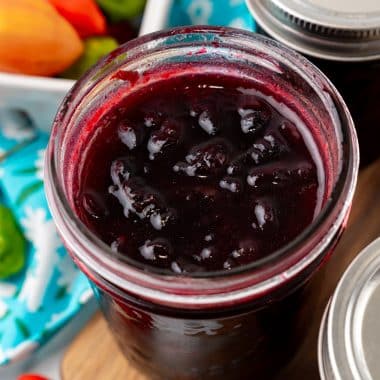 fresh cherry habanero jam in a small glass mason jar