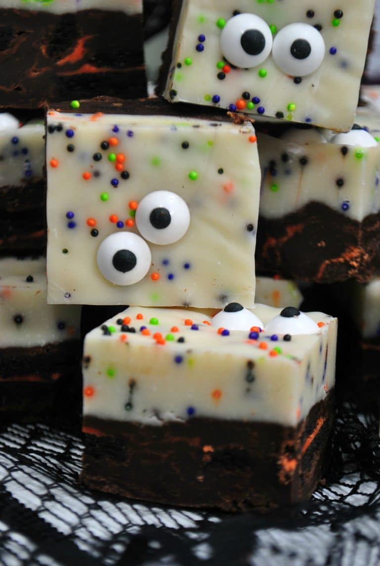 pieces of monster fudge stacked together on a black webbed tablecloth