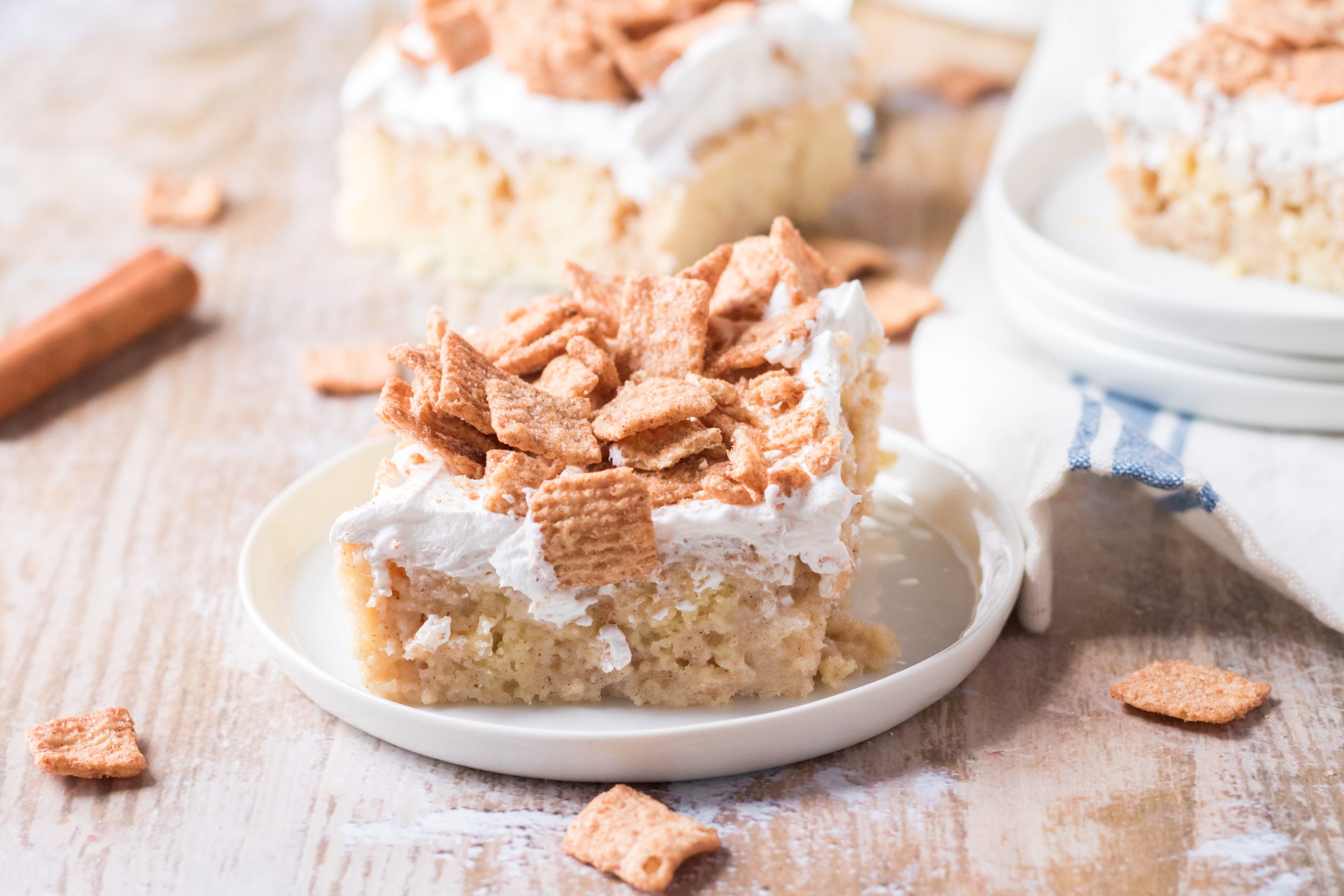a slice of cinnamon toast crunch poke cake on a small white plate