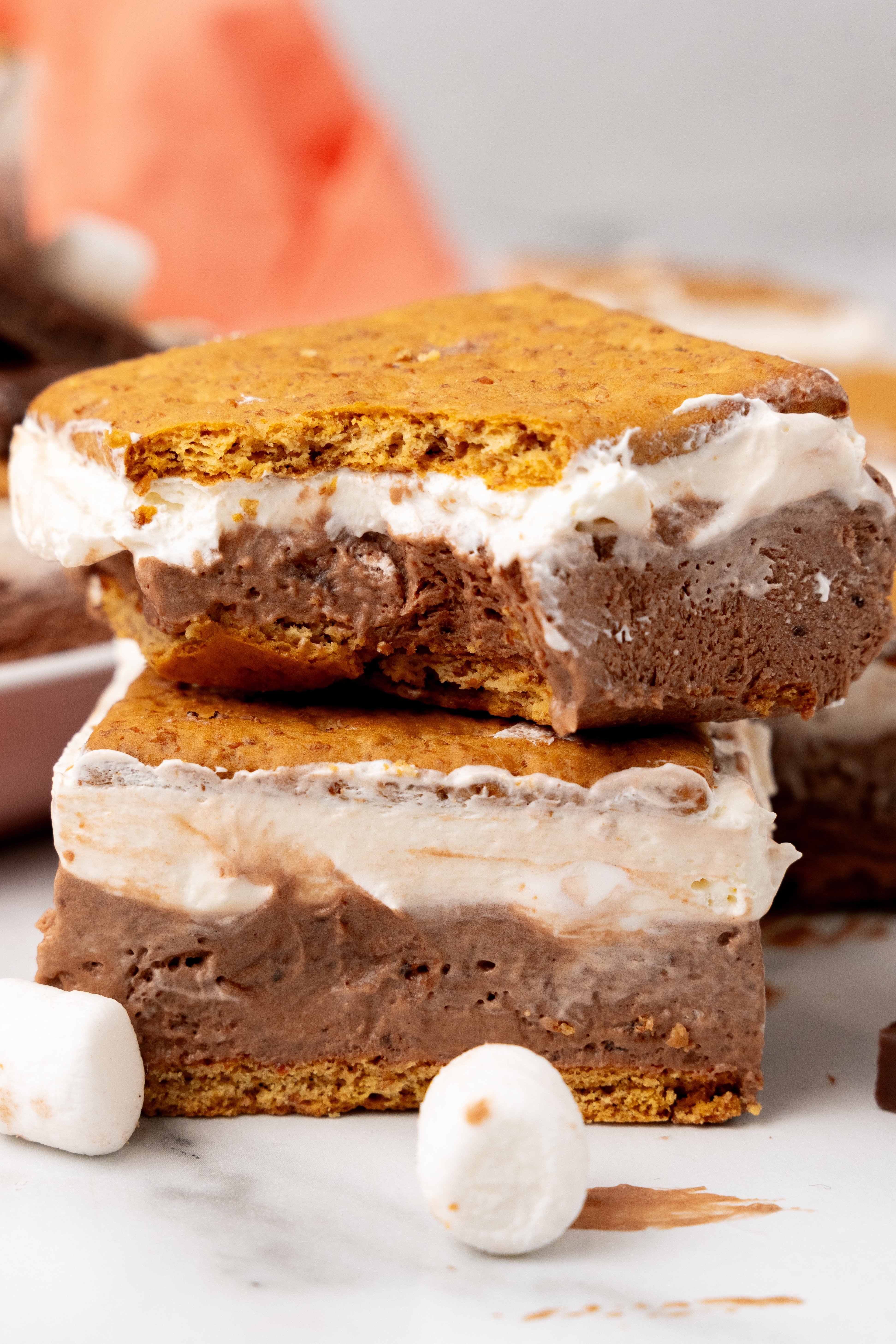 a stack of two frozen s'mores with a bite taken out of the corner of the top piece